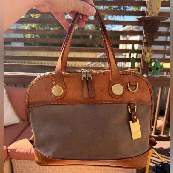 This is a Dooney & Bourke cabriolet canvas and vachetta leather satchel. - Picture 1 of 7